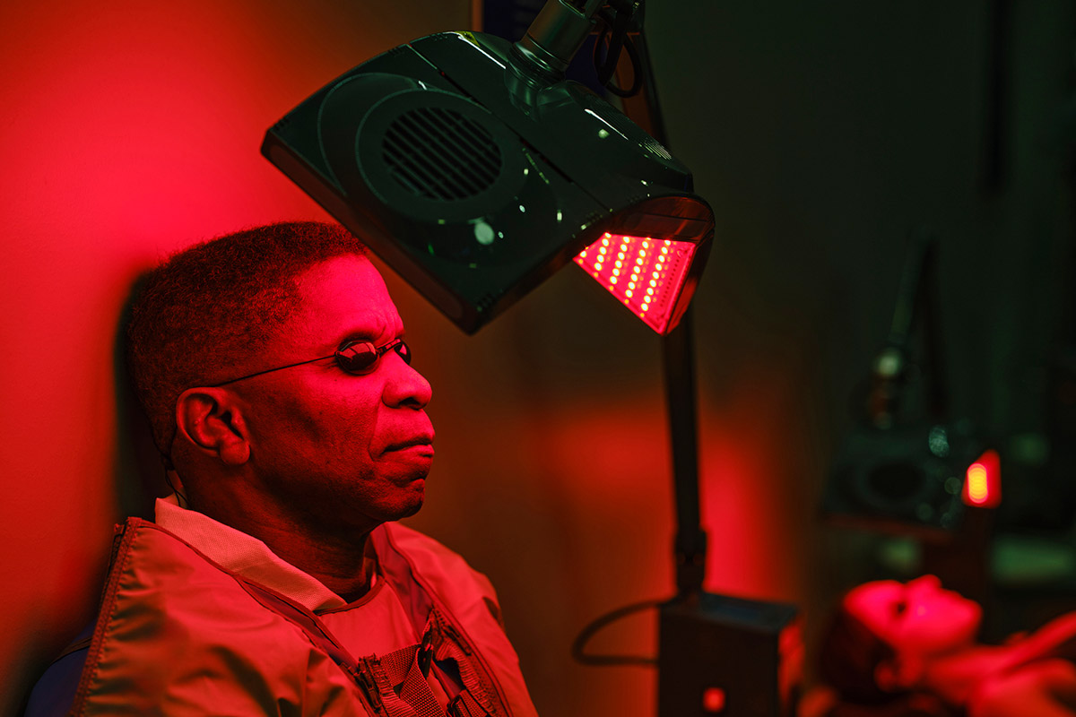 hombre aplicándose terapia de luz infraroja