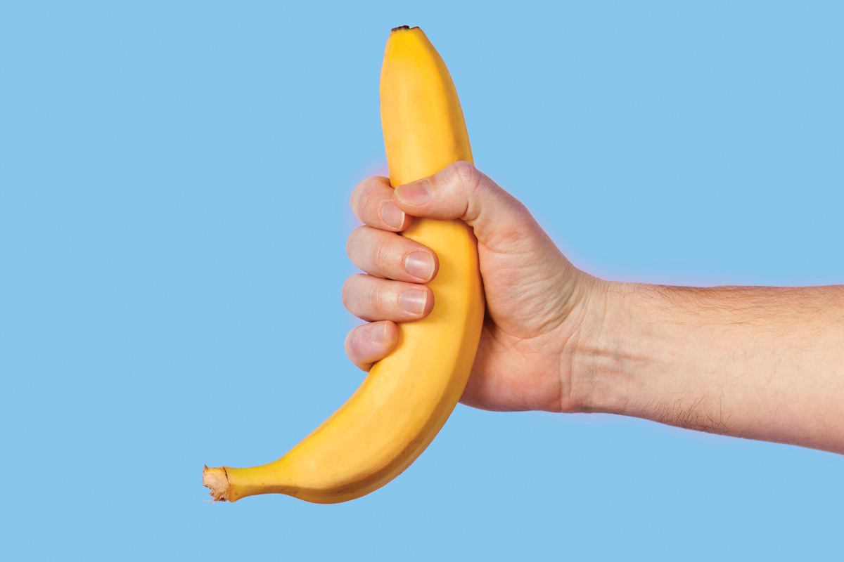 hombre sosteniendo un plátano en la mano